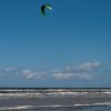 Kitesurfing on a blue sky background