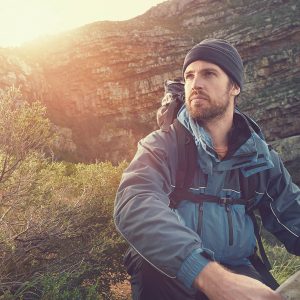 Portrait of adventure man with map and extreme explorer gear on